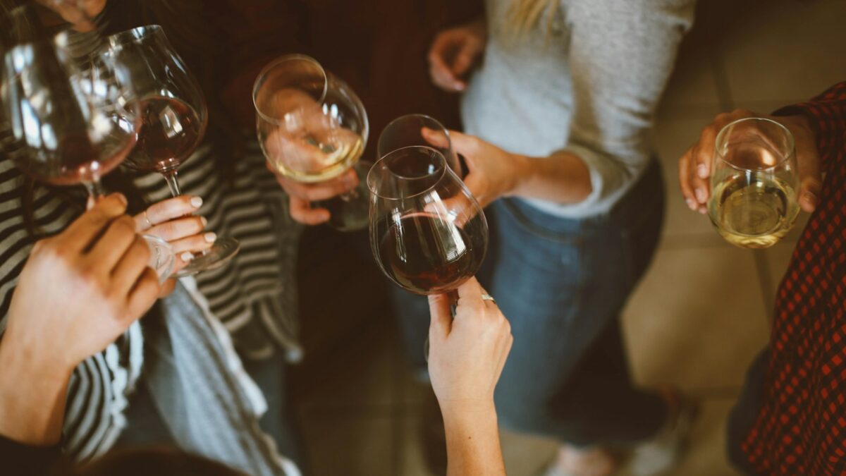 group of people tossing wine glass