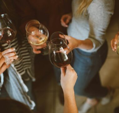 group of people tossing wine glass